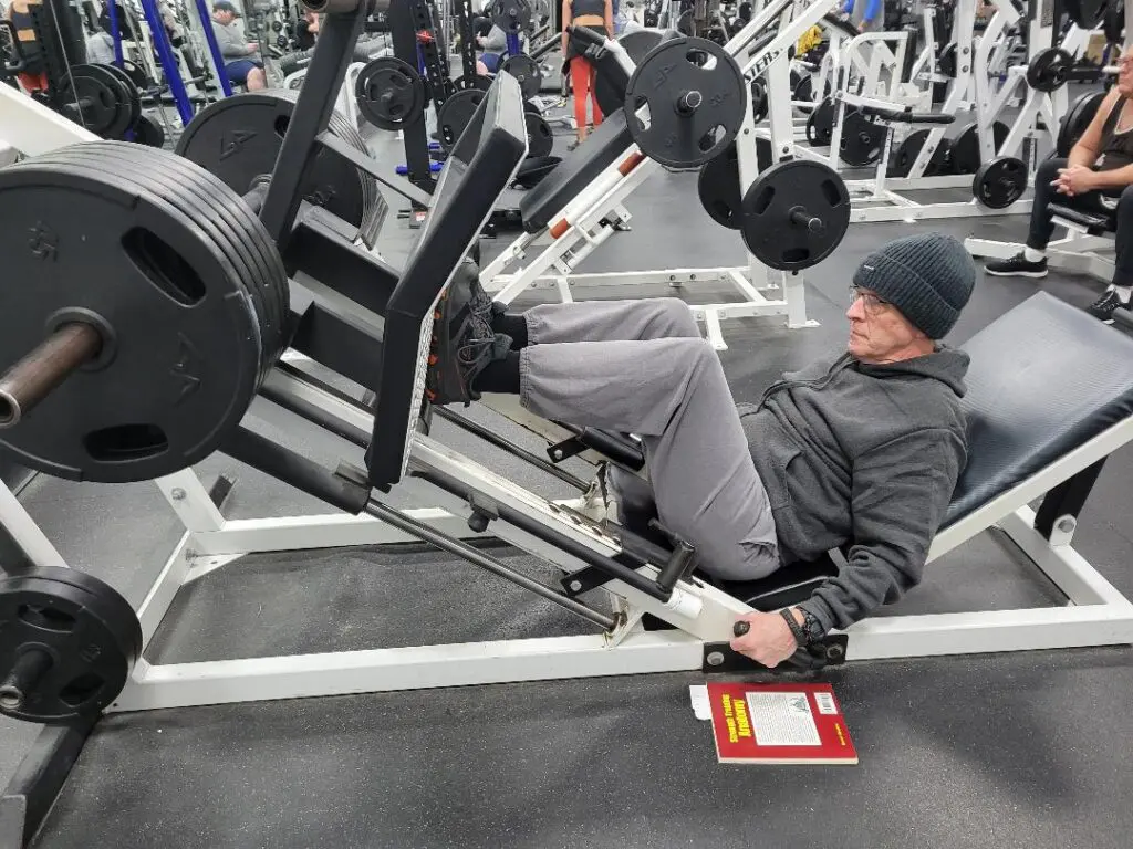 Man performing heavy leg press workout