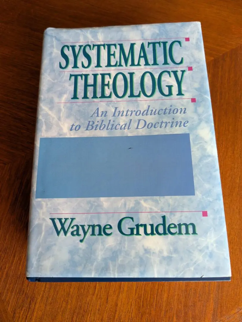 Blue Systematic Theology book on wooden table